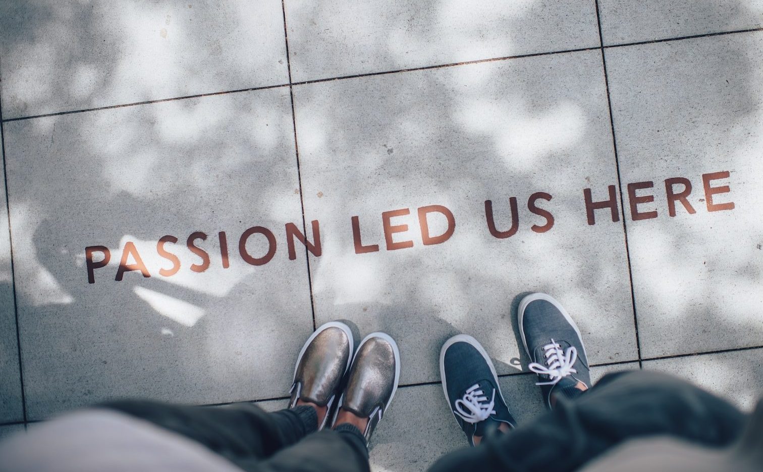 two person standing on gray tile paving