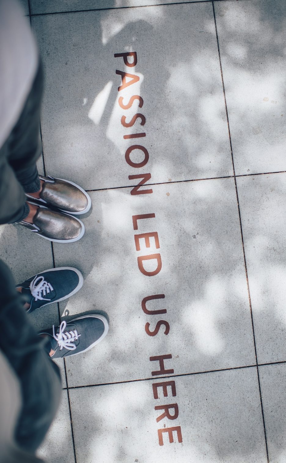 two person standing on gray tile paving
